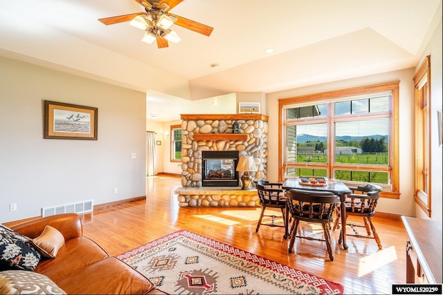 22 Pleasant Valley Ln, Sheridan, WY 82801 - dining area featuring light wood-type flooring, a fireplace, a ceiling fan, and baseboards