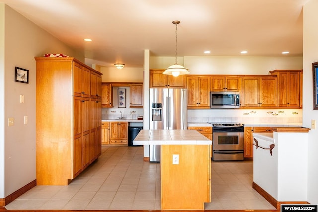 22 Pleasant Valley Ln, Sheridan, WY 82801 - kitchen with stainless steel appliances, tile counters, a kitchen island, a sink, and recessed lighting