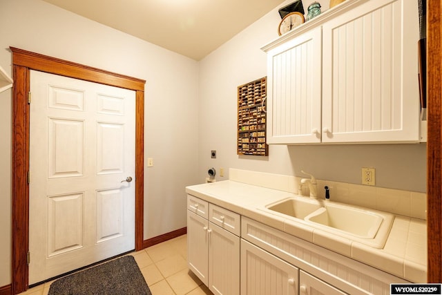 22 Pleasant Valley Ln, Sheridan, WY 82801 - laundry area featuring cabinet space, hookup for an electric dryer, light tile patterned flooring, and baseboards