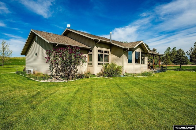 22 Pleasant Valley Ln, Sheridan, WY 82801 - view of side of property featuring a lawn and central AC unit