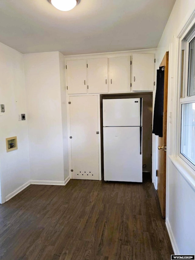 1308 Howell, Worland, WY 82401 - kitchen with freestanding refrigerator, dark wood-type flooring, baseboards, and white cabinetry
