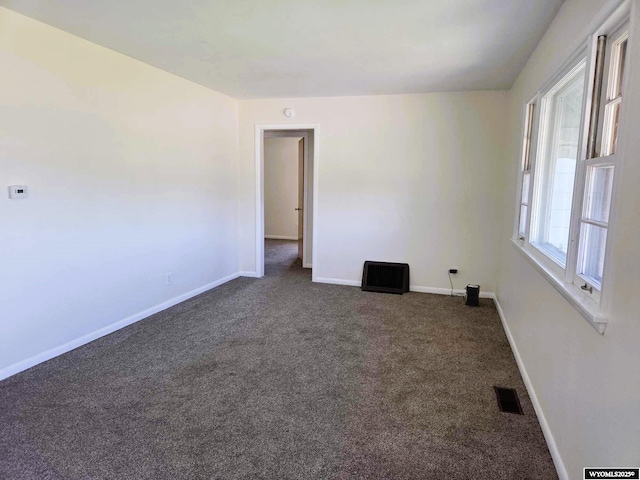1308 Howell, Worland, WY 82401 - spare room with dark carpet and baseboards