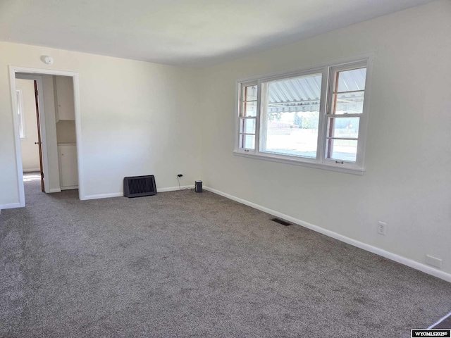 1308 Howell, Worland, WY 82401 - unfurnished room with dark colored carpet and baseboards