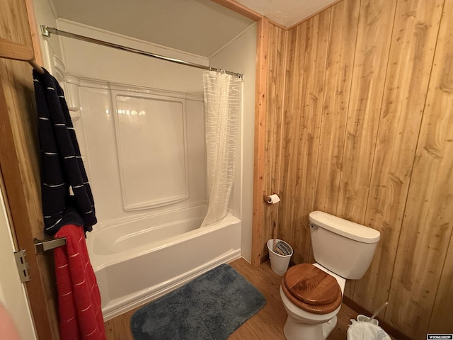 83 Calvert Ave, Hanna, WY 82327 - full bathroom with toilet, wood walls, wood finished floors, and shower / tub combo with curtain