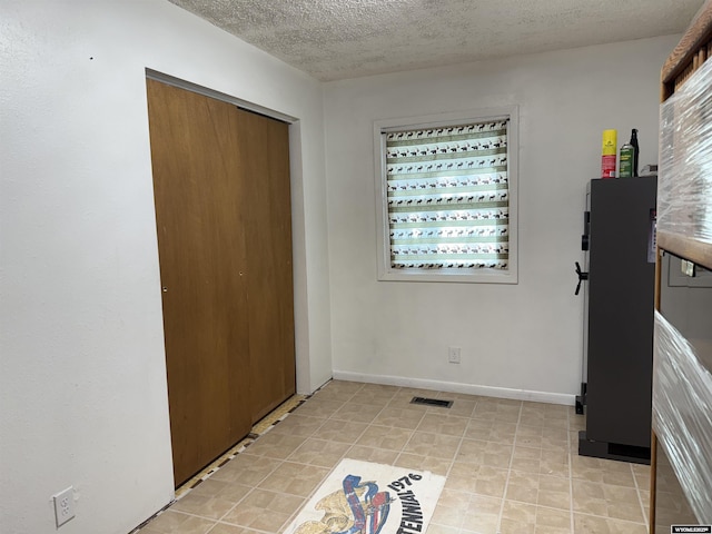 83 Calvert Ave, Hanna, WY 82327 - foyer entrance with a textured ceiling, baseboards, and healthy amount of natural light
