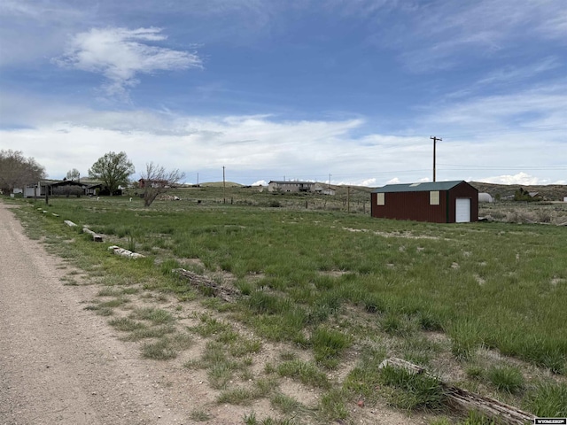 83 Calvert Ave, Hanna, WY 82327 - view of yard with an outbuilding, a garage, and a view of rural / pastoral area