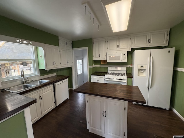 420 S 6th St, Riverton, WY 82501 - kitchen featuring white appliances, a sink, butcher block counters, white cabinetry, and a kitchen island