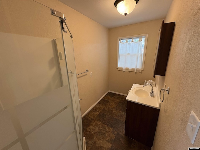 420 S 6th St, Riverton, WY 82501 - bathroom featuring vanity, stone finish floors, and baseboards