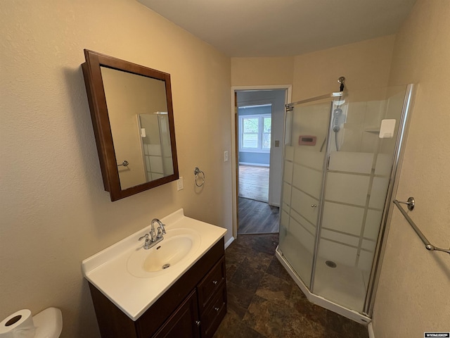 420 S 6th St, Riverton, WY 82501 - bathroom with vanity, a stall shower, toilet, and stone finish flooring