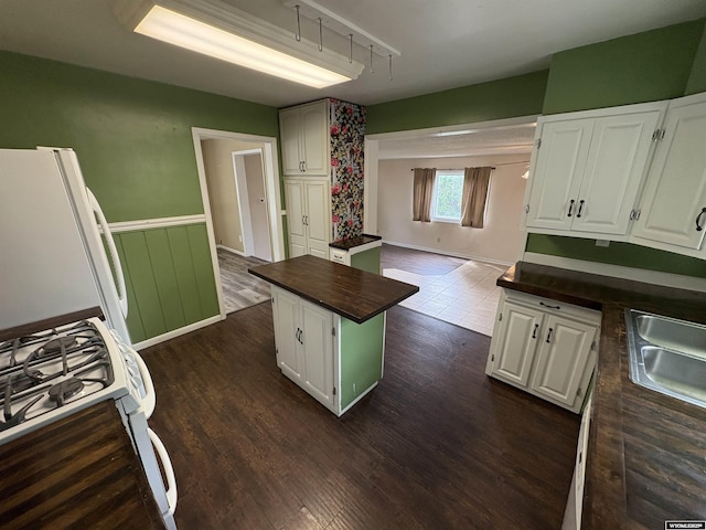 420 S 6th St, Riverton, WY 82501 - kitchen with freestanding refrigerator, butcher block counters, track lighting, white cabinetry, and dark wood-type flooring