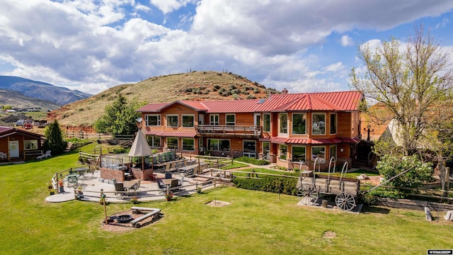 30 Nielsen Trl, Cody, WY 82414 - rear view of house with a patio, a mountain view, and metal roof