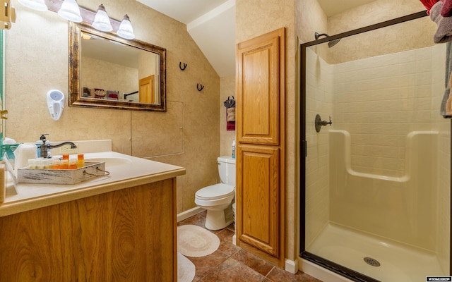 30 Nielsen Trl, Cody, WY 82414 - bathroom with a stall shower, toilet, vanity, and lofted ceiling