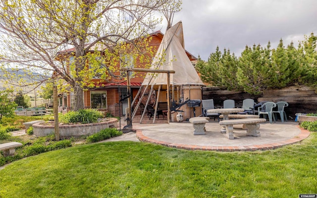 30 Nielsen Trl, Cody, WY 82414 - back of house featuring a patio and a lawn