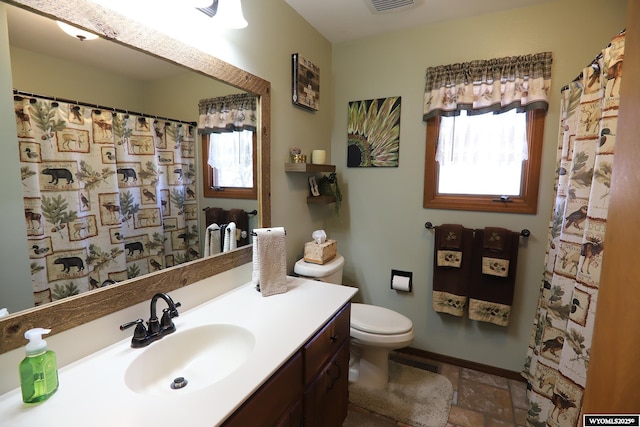478 Upper French Creek Rd, Buffalo, WY 82834 - full bathroom with toilet, vanity, and stone tile flooring
