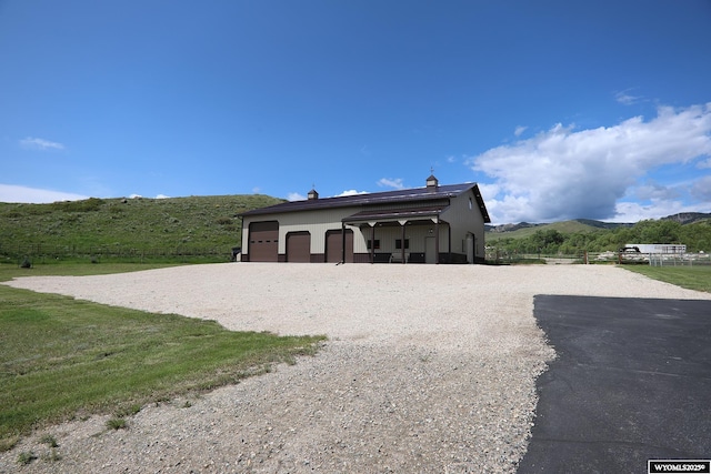 478 Upper French Creek Rd, Buffalo, WY 82834 - view of front of home with a mountain view, stucco siding, and a garage