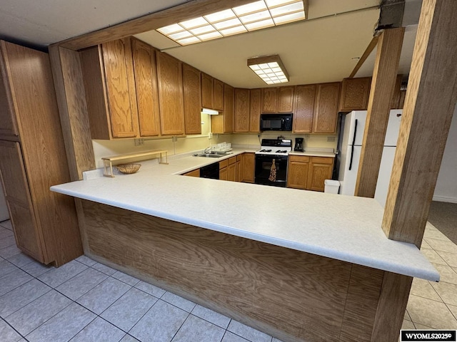 402 S 7th St E, Riverton, WY 82501 - kitchen with black appliances, a sink, light tile patterned floors, light countertops, and a peninsula