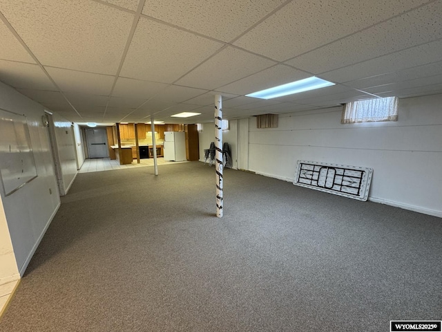 402 S 7th St E, Riverton, WY 82501 - basement featuring a drop ceiling, freestanding refrigerator, and carpet flooring