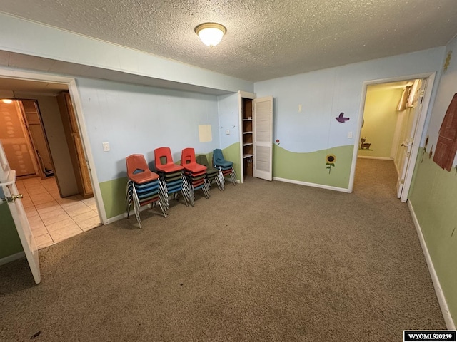 402 S 7th St E, Riverton, WY 82501 - rec room with carpet flooring, a textured ceiling, and baseboards