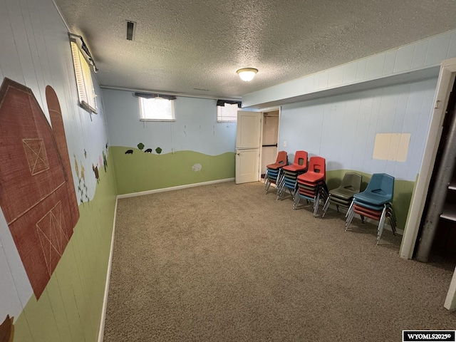 402 S 7th St E, Riverton, WY 82501 - sitting room featuring carpet flooring, a textured ceiling, and wood walls