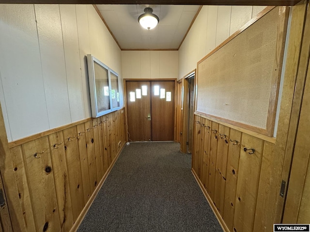 402 S 7th St E, Riverton, WY 82501 - hallway with wooden walls, crown molding, and dark colored carpet