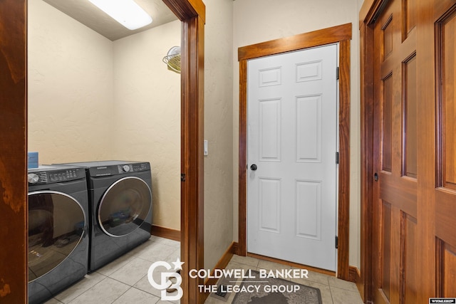 972 Cornwall St, Casper, WY 82609 - laundry room featuring washing machine and dryer, light tile patterned flooring, and baseboards
