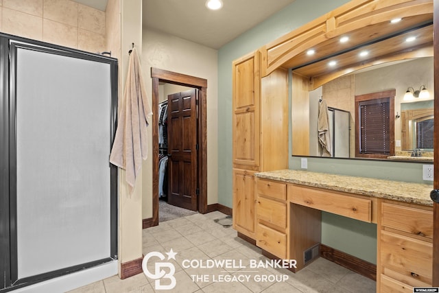 972 Cornwall St, Casper, WY 82609 - bathroom featuring a shower stall, vanity, recessed lighting, baseboards, and tile patterned floors