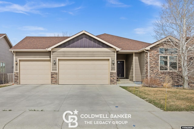 972 Cornwall St, Casper, WY 82609 - view of front of property featuring stone siding, an attached garage, concrete driveway, and roof with shingles