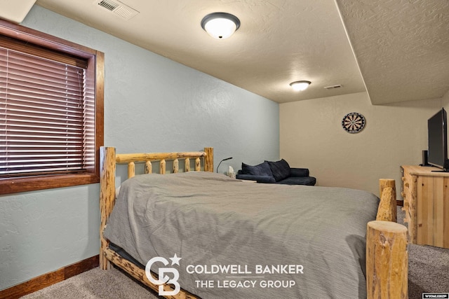 972 Cornwall St, Casper, WY 82609 - bedroom with carpet, a textured wall, baseboards, and a textured ceiling