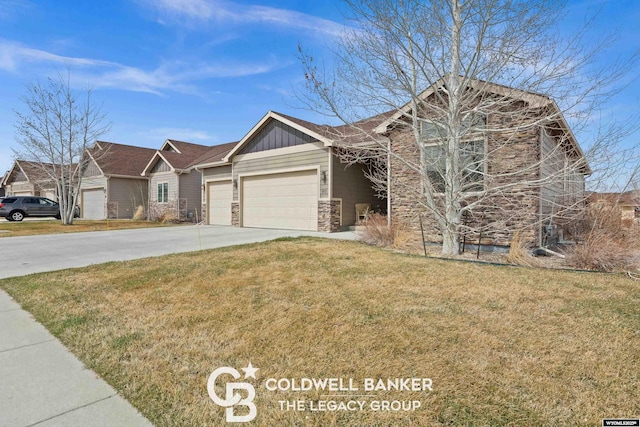 972 Cornwall St, Casper, WY 82609 - view of front facade with an attached garage, a front yard, concrete driveway, stone siding, and board and batten siding
