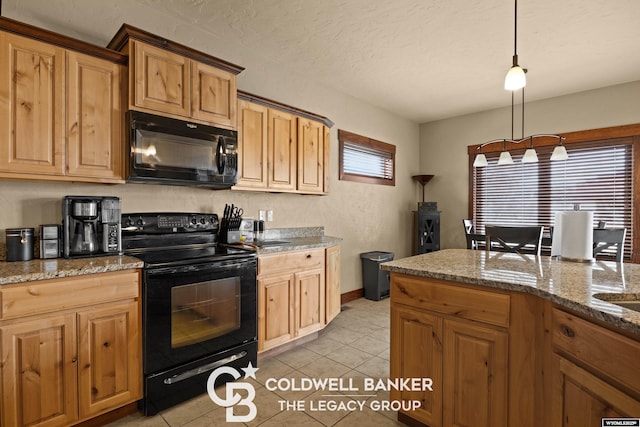 972 Cornwall St, Casper, WY 82609 - kitchen with black appliances, light tile patterned flooring, dark stone counters, pendant lighting, and a textured ceiling