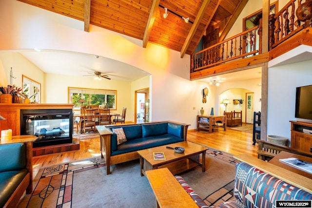 43 Fish Hatchery Rd, Story, WY 82842 - living area with arched walkways, wood ceiling with exposed beams, wood finished floors, ceiling fan, and track lighting