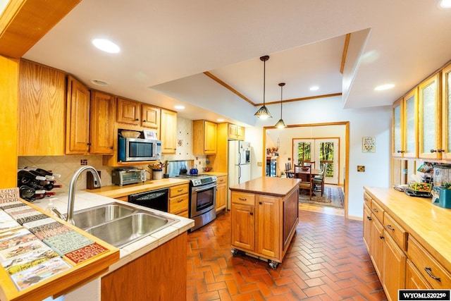 43 Fish Hatchery Rd, Story, WY 82842 - kitchen with appliances with stainless steel finishes, a sink, tasteful backsplash, recessed lighting, and brick floors