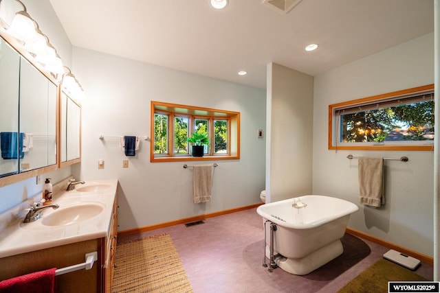 43 Fish Hatchery Rd, Story, WY 82842 - full bath with a freestanding tub, double vanity, baseboards, and recessed lighting