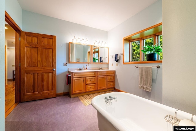 43 Fish Hatchery Rd, Story, WY 82842 - bathroom featuring a freestanding tub, double vanity, and baseboards