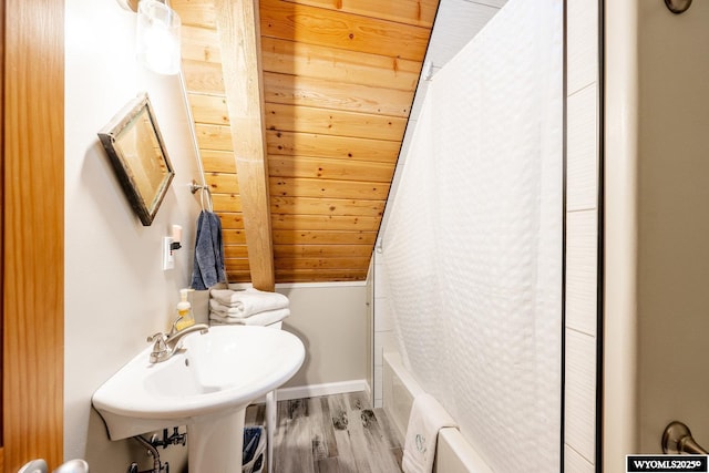 43 Fish Hatchery Rd, Story, WY 82842 - full bath featuring wood finished floors, shower / bath combination with curtain, vaulted ceiling, a sink, and baseboards
