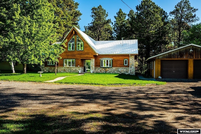 43 Fish Hatchery Rd, Story, WY 82842 - rustic home featuring stone siding, a garage, a front lawn, and an outbuilding