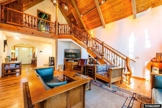43 Fish Hatchery Rd, Story, WY 82842 - living area with wood finished floors, stairway, high vaulted ceiling, arched walkways, and wood ceiling with exposed beams