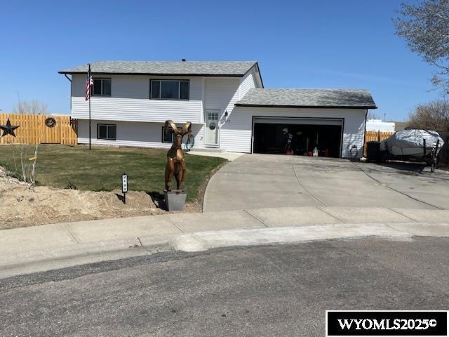 2122 E 23rd St, Casper, WY 82601 - view of front of house with an attached garage and concrete driveway