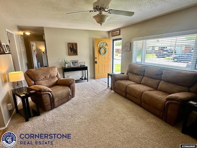 3024 Hamilton Way, Casper, WY 82609 - living area featuring a textured ceiling, carpet flooring, a ceiling fan, and baseboards