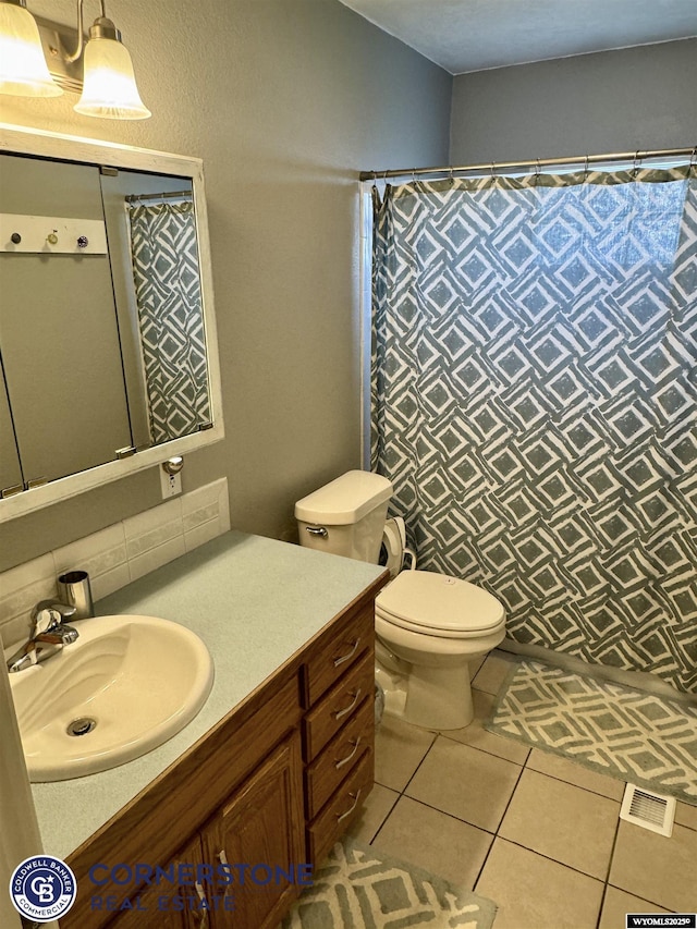 3024 Hamilton Way, Casper, WY 82609 - bathroom featuring vanity, toilet, a shower with shower curtain, tile patterned flooring, and decorative backsplash