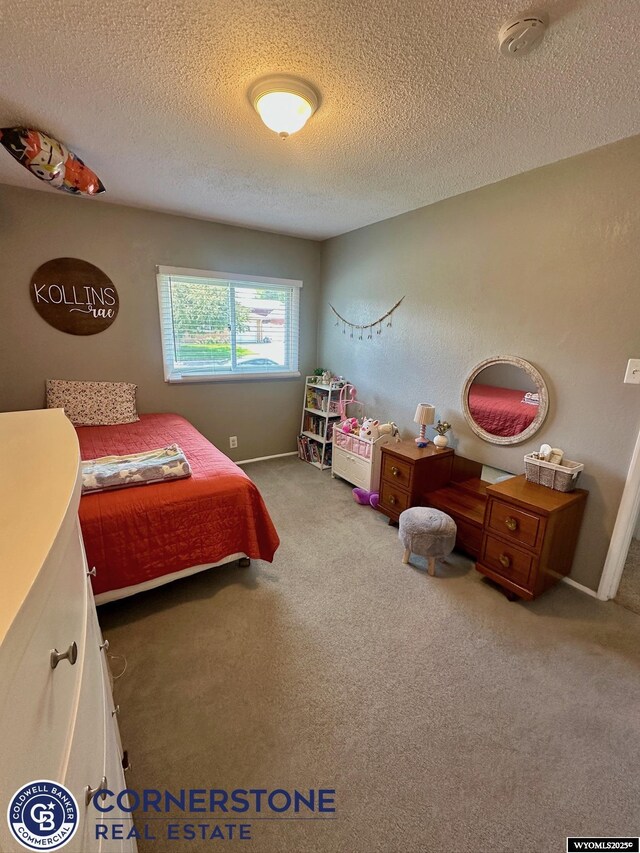 3024 Hamilton Way, Casper, WY 82609 - carpeted bedroom with a textured ceiling and baseboards