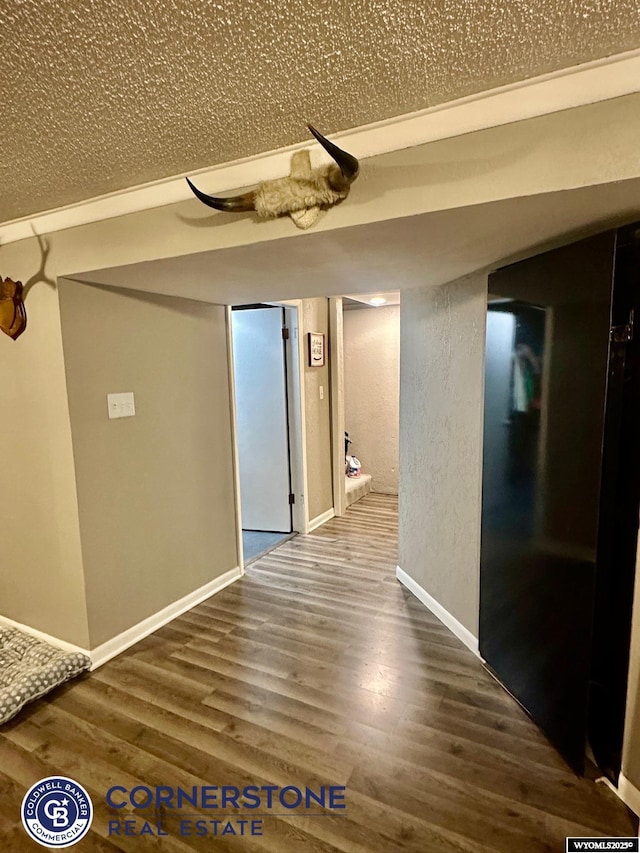 3024 Hamilton Way, Casper, WY 82609 - hallway featuring wood finished floors, a textured wall, and baseboards