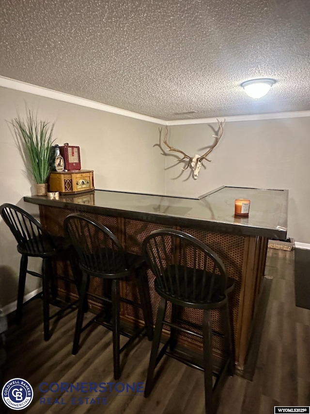 3024 Hamilton Way, Casper, WY 82609 - indoor dry bar with a textured ceiling, wood finished floors, and crown molding