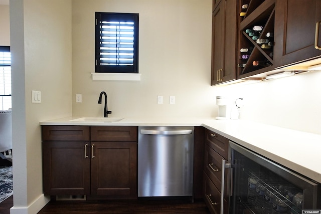 3685 Timber Wolf Ct, Casper, WY 82604 - bar area with stainless steel dishwasher, beverage cooler, a sink, dark wood-style floors, and plenty of natural light