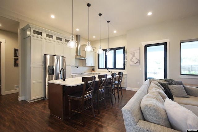 3685 Timber Wolf Ct, Casper, WY 82604 - kitchen with wall chimney range hood, open floor plan, light countertops, dark wood-style floors, and recessed lighting