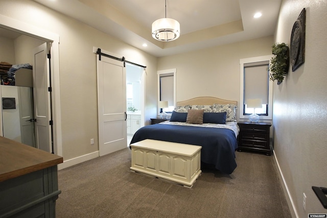 3685 Timber Wolf Ct, Casper, WY 82604 - bedroom featuring a barn door, baseboards, dark carpet, recessed lighting, and ensuite bath