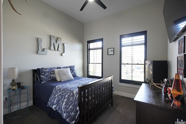 3685 Timber Wolf Ct, Casper, WY 82604 - bedroom with carpet flooring, multiple windows, baseboards, and a ceiling fan