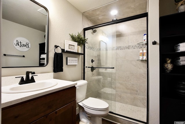 3685 Timber Wolf Ct, Casper, WY 82604 - bathroom featuring vanity, a stall shower, toilet, and a textured wall