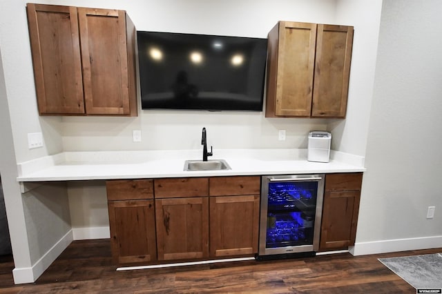 3685 Timber Wolf Ct, Casper, WY 82604 - bar featuring beverage cooler, a sink, dark wood-style floors, and baseboards