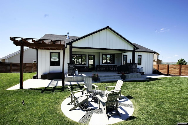 3685 Timber Wolf Ct, Casper, WY 82604 - back of property featuring board and batten siding, a fire pit, and a shingled roof